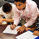 Young immigrants fill out paperwork. (Paul J. Richards/AFP/Getty Images)